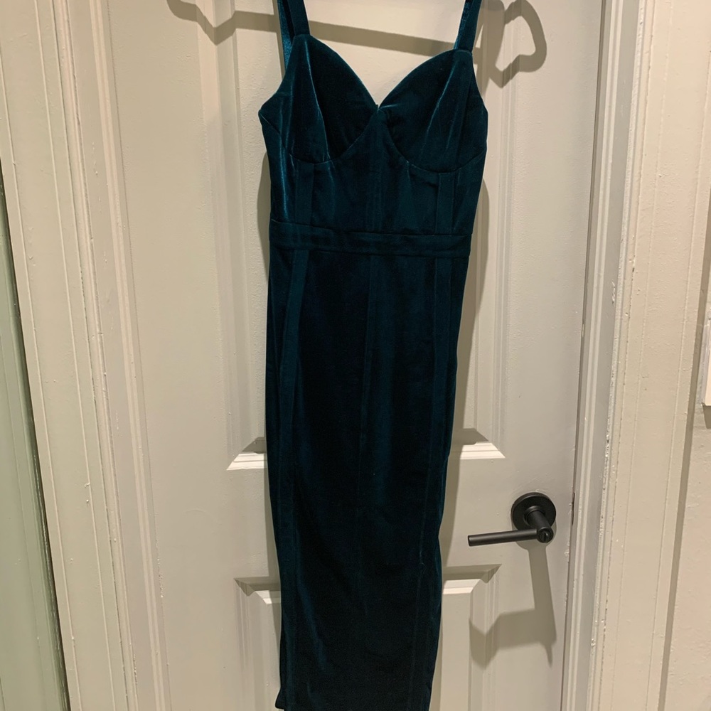 Emerald green velvet body-con dress.